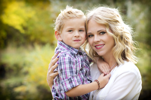 A mother and her toddler son are smiling